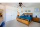Bright bedroom with a queen bed, shuttered windows, ceiling fan, and closet doors at 831 Mandalay Ave, Clearwater, FL 33767
