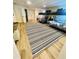 Large bedroom with two bunkbeds, striped rug, light colored walls, and light wood colored flooring at 831 Mandalay Ave, Clearwater, FL 33767