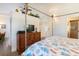 Serene bedroom featuring a four-poster bed, stylish dresser, and leafy décor at 831 Mandalay Ave, Clearwater, FL 33767