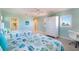 Bright bedroom with twin beds, coastal bedding, a desk, and shuttered windows providing natural light at 831 Mandalay Ave, Clearwater, FL 33767