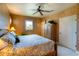 Comfortable bedroom featuring a queen bed, ceiling fan, shuttered windows, and warm earth tones at 831 Mandalay Ave, Clearwater, FL 33767