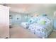 Charming bedroom featuring two twin beds with coastal-themed bedding, a desk, and serene decor at 831 Mandalay Ave, Clearwater, FL 33767