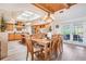 Dining room and kitchen feature hardwood floors, wood cabinets and lots of natural light from windows and skylight at 831 Mandalay Ave, Clearwater, FL 33767