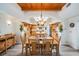 Bright dining room adjacent to the open kitchen features wood ceiling, wood floors and lots of natural light at 831 Mandalay Ave, Clearwater, FL 33767