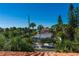 View of palm trees and neighborhood homes with the Gulf in the distance at 831 Mandalay Ave, Clearwater, FL 33767