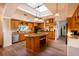 Spacious kitchen featuring a skylight, island with seating, and stainless steel appliances at 831 Mandalay Ave, Clearwater, FL 33767