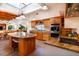 Spacious kitchen featuring a skylight, island with seating, and stainless steel appliances at 831 Mandalay Ave, Clearwater, FL 33767