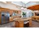 Open kitchen with granite countertops, a large island, and a view of the dining area at 831 Mandalay Ave, Clearwater, FL 33767