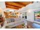 Spacious living room with wood ceiling, hardwood floors and access to the dining room, kitchen, and outdoor patio at 831 Mandalay Ave, Clearwater, FL 33767