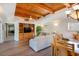 Living room and dining area with hardwood floors, wood ceiling, and access to the stairs at 831 Mandalay Ave, Clearwater, FL 33767