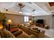 Entertainment room with tiered seating, comfortable couch, and ornate ceiling with recessed lighting and TV at 831 Mandalay Ave, Clearwater, FL 33767