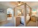 Spacious main bedroom with a four-poster bed and a glimpse of the luxurious en-suite bathroom at 831 Mandalay Ave, Clearwater, FL 33767