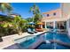 Inviting pool area with lounge chairs, umbrellas, and tropical landscaping offering a great outdoor experience at 831 Mandalay Ave, Clearwater, FL 33767