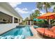 Backyard pool with spa, patio seating, and lush tropical landscaping at 831 Mandalay Ave, Clearwater, FL 33767