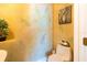 Charming powder room features decorative wall art and leafy wallpaper, adding a touch of nature to the space at 831 Mandalay Ave, Clearwater, FL 33767