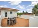 Lovely rooftop deck with a table and seating, set against a backdrop of blue skies and leafy trees at 831 Mandalay Ave, Clearwater, FL 33767