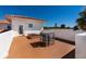 Spacious rooftop deck with a table and seating, offering stunning views and outdoor living space at 831 Mandalay Ave, Clearwater, FL 33767