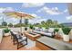 Stylish rooftop deck featuring comfortable seating, a fire pit, and views of the surrounding area at 831 Mandalay Ave, Clearwater, FL 33767