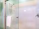 Close-up of shower with decorative tile detail, glass enclosure, and chrome hardware at 831 Mandalay Ave, Clearwater, FL 33767