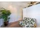 Cozy sitting area with tropical-themed futon, wooden desk, and leafy décor, ideal for relaxation at 831 Mandalay Ave, Clearwater, FL 33767