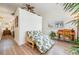 Relaxing sitting area features a daybed, wooden desk, and tropical plants, creating a tranquil space at 831 Mandalay Ave, Clearwater, FL 33767