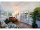 Bright sitting area features a wooden desk, plush daybed, and tropical plants, creating an inviting retreat at 831 Mandalay Ave, Clearwater, FL 33767