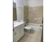 Bathroom featuring a single sink vanity, shower and tub combo, and ceramic tile flooring at 8636 Tahoe Ct # 13, Tampa, FL 33614