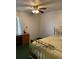 Bedroom showcasing a gold-tone metal bed frame, ceiling fan, and desk by the window at 8636 Tahoe Ct # 13, Tampa, FL 33614