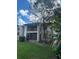 This condo features a screened in porch, balcony, and mature trees in a well-maintained exterior at 8636 Tahoe Ct # 13, Tampa, FL 33614