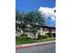 View of the exterior of the apartment with trees on a sunny day at 8636 Tahoe Ct # 13, Tampa, FL 33614