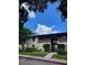 Apartment complex exterior with lawn and trees on a sunny day at 8636 Tahoe Ct # 13, Tampa, FL 33614