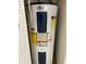 Close-up of a Whirlpool water heater with an Energy Guide label and safety warnings at 8636 Tahoe Ct # 13, Tampa, FL 33614