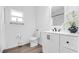 Bathroom featuring modern vanity with black hardware, white countertop and decorative plant at 9429 Northcliffe Blvd, Spring Hill, FL 34606