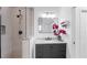 Updated bathroom features a glass walk-in shower, gray vanity, and decorative accents at 9429 Northcliffe Blvd, Spring Hill, FL 34606