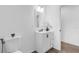 Modern bathroom with black fixtures, white vanity and a decorative plant on the countertop at 9429 Northcliffe Blvd, Spring Hill, FL 34606