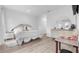 Bright bedroom with a white bed set, decorative mirror, and sleek dresser, offering comfort and style at 9429 Northcliffe Blvd, Spring Hill, FL 34606