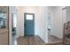 Inviting foyer with sleek floors, featuring a blue front door and views into adjacent rooms at 9429 Northcliffe Blvd, Spring Hill, FL 34606