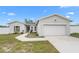 Charming single-story home featuring a two-car garage and a well-manicured front yard with a tidy walkway at 9429 Northcliffe Blvd, Spring Hill, FL 34606