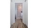 Hallway shows the bathroom featuring a glass enclosed shower and updated fixtures at 9429 Northcliffe Blvd, Spring Hill, FL 34606