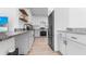 Contemporary kitchen featuring white cabinets, granite countertops, and stainless steel appliances at 9429 Northcliffe Blvd, Spring Hill, FL 34606