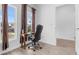 Home office featuring a traditional wooden desk with a black office chair and large windows at 9429 Northcliffe Blvd, Spring Hill, FL 34606