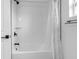 Bathtub with white tiled surround and clear glass door at 9429 Northcliffe Blvd, Spring Hill, FL 34606