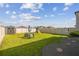 Large backyard featuring well-maintained grass, fence, and storage shed at 9440 Lemon Drop Loop, Sun City Center, FL 33573