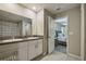 Bathroom features double sinks, granite countertops, and walk-in shower at 9440 Lemon Drop Loop, Sun City Center, FL 33573