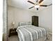 This relaxing bedroom features a ceiling fan, carpet flooring, and a wardrobe at 9440 Lemon Drop Loop, Sun City Center, FL 33573