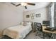 This comfortable bedroom has a ceiling fan, carpet flooring, and a dedicated workspace at 9440 Lemon Drop Loop, Sun City Center, FL 33573