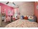 Bedroom with desk, toys, rainbow wall decor, and window at 9440 Lemon Drop Loop, Sun City Center, FL 33573