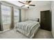 This relaxing bedroom features a ceiling fan, carpet flooring, and a wardrobe at 9440 Lemon Drop Loop, Sun City Center, FL 33573