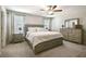 Bright bedroom features neutral walls, a ceiling fan, and light wood furniture at 9440 Lemon Drop Loop, Sun City Center, FL 33573