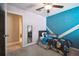 bedroom with accent wall, toys and ensuite bathroom at 9440 Lemon Drop Loop, Sun City Center, FL 33573